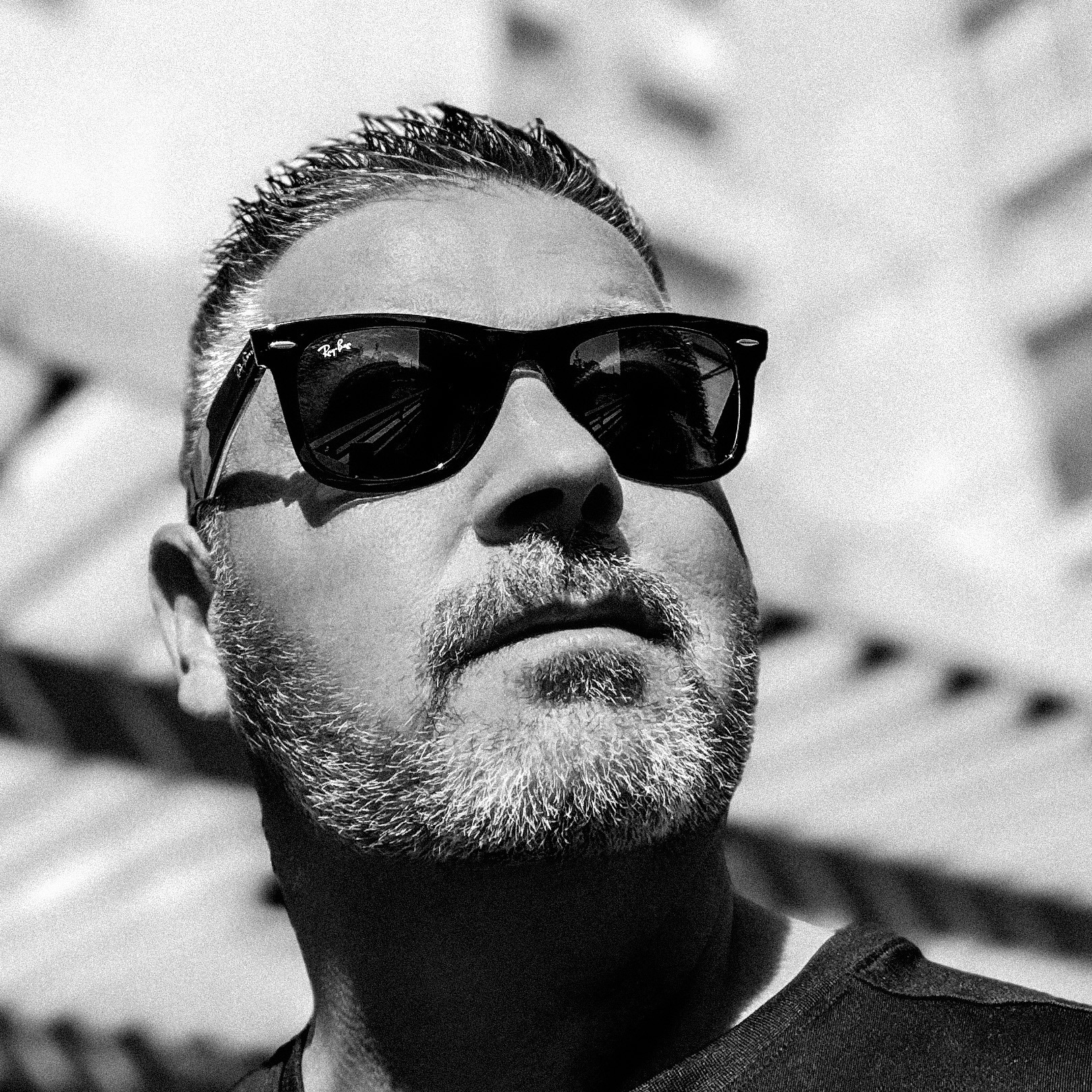 Black-and-white portrait of Chris Denbow wearing sunglasses